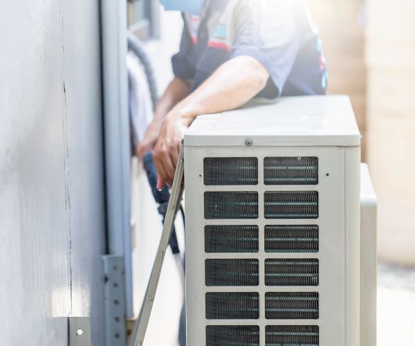 Outdoor air conditioner condenser unit being installed