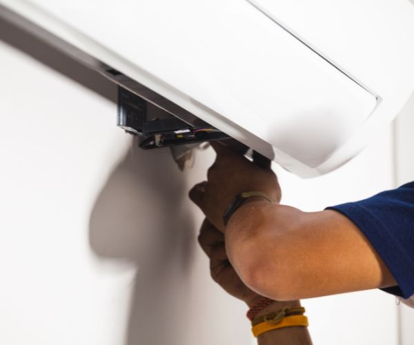 Close-up of a JGA Premier technician servicing an indoor AC unit